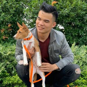 Khách hàng bế bé chó con Basenji ngoài trời trong ngày bàn giao từ Chạm Pets Family